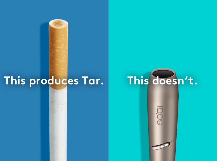 Cigarette filter with brown combustion stains compared to IQOS 3 DUO holder.