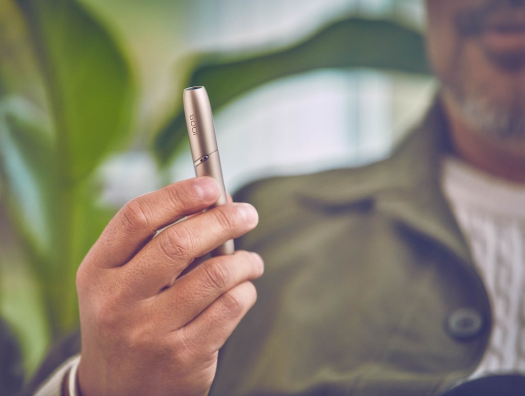 Man showing a gold IQOS holder