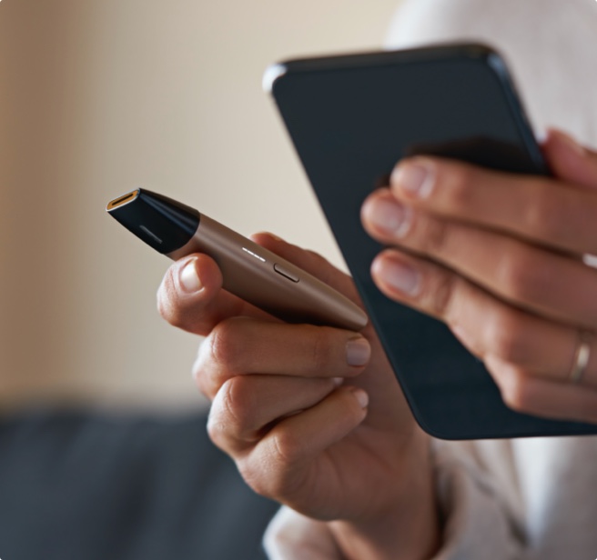 Man holding an IQOS device .